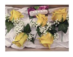 Yellow rose buttonholes with gypsophila accent